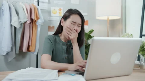 Female worker yawning while working in home office Stock Footage 133198512