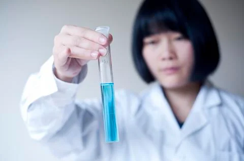 Female workers doing the experiment Stock Photos