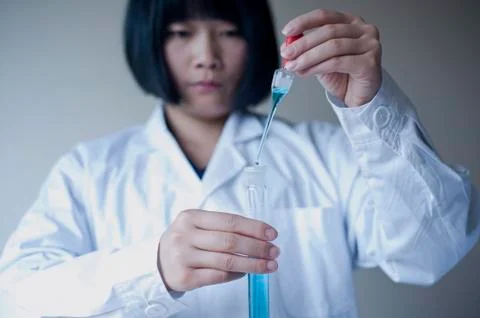 Female workers doing the experiment Stock Photos
