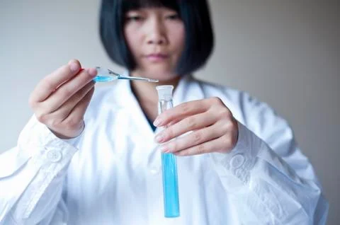 Female workers doing the experiment Stock Photos