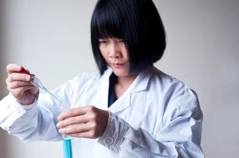 Female workers doing the experiment Stock Photos