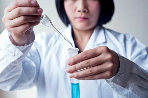 Female workers doing the experiment Stock Photos