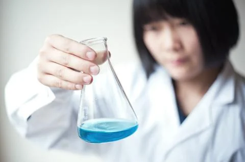 Female workers doing the experiment Stock Photos