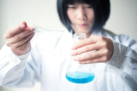 Female workers doing the experiment Stock Photos