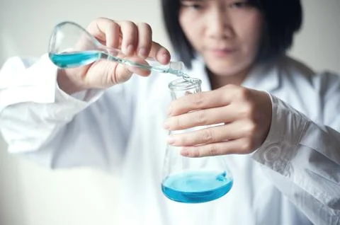 Female workers doing the experiment Stock Photos