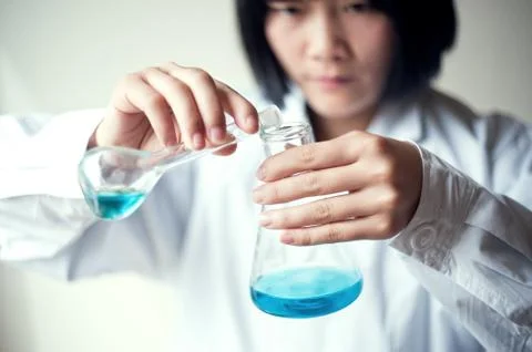 Female workers doing the experiment Stock Photos