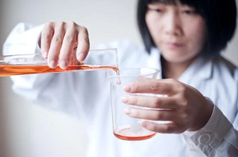 Female workers doing the experiment Stock Photos