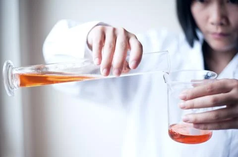 Female workers doing the experiment Stock Photos