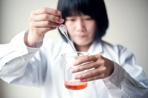 Female workers doing the experiment Stock Photos
