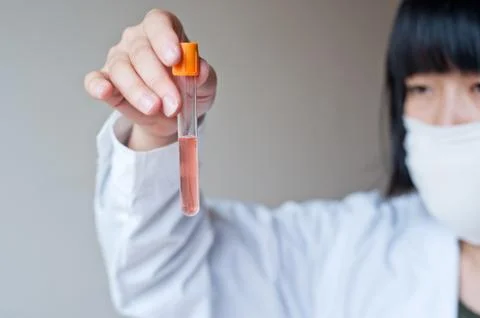 Female workers doing the experiment Stock Photos