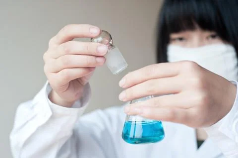 Female workers doing the experiment Stock Photos