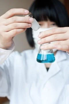 Female workers doing the experiment Stock Photos