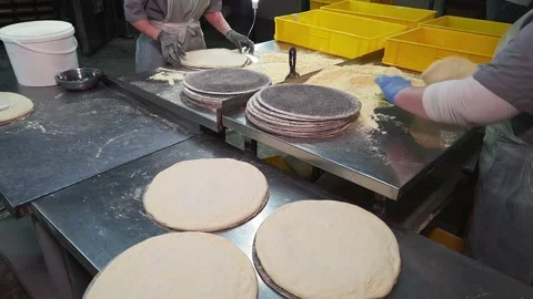 Female Workers Quickly making a Dough for Pizza on a industrial Bakery Plant. Stock Footage 168054880