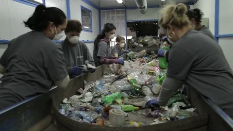 Female workers sorting garbage on a production line Stock Footage 72857907
