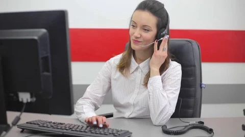 Female working on computer and talking on the telephone in call center Stock Footage 74095993