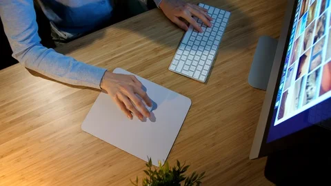 Female working on computer at night. Crop view of hands of woman in comfortable Stock Footage 91653856