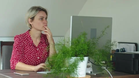 Female working desktop computer pc solve problem think looking computer screen Stock Footage 235733682