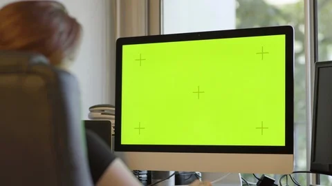 Female working on personal computer with Mock-up Green Screen in her studio. Video stock 111927660