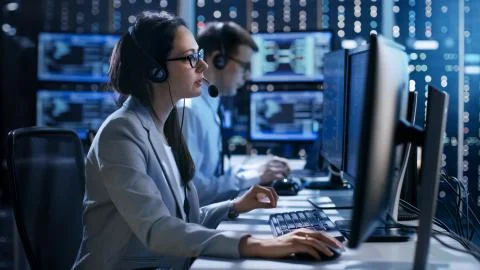 Female working in a Technical Support Team Gives Instructions with the Help o Stock Photos