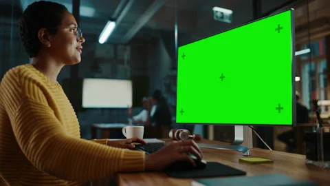 Female Works on Computer with Green Screen in Creative Office Video stock 143744874