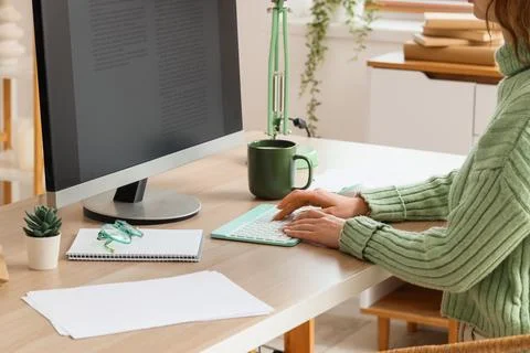 Female writer editing manuscript on computer before publishing in office Stock Photos