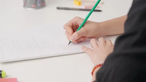 Female writing correct answer in standard exam test paper book with pencil Stock Footage 280168041