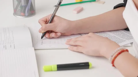 Female writing correct answer in standard exam test paper book with pen. Student Stock Footage 280168223