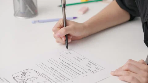 Female writing correct answer in standard exam test paper book with pen. Student Stock Footage 280168482