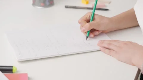 Female writing correct answer in standard exam test paper book with pencil Stock Footage 280168526