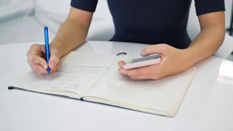 Female writing in notepad Stock Footage 103042031