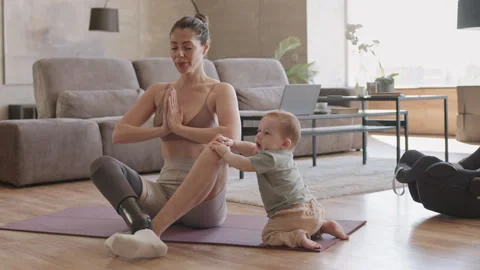 Female Yogi with Disability Babysitting while Meditating Video stock 306647649