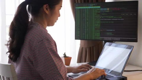 Female young Asian program engineer working with computer, coding analysing data Stock Footage 146840744