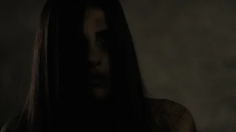 Female zombie attacking and killing man walking in garage slow motion extreme Stock Footage 77689488