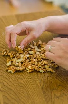 Females hands t the table sorting walnuts Stock Photos
