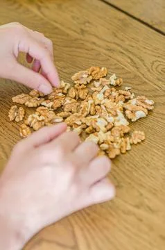 Females hands t the table sorting walnuts Stock Photos
