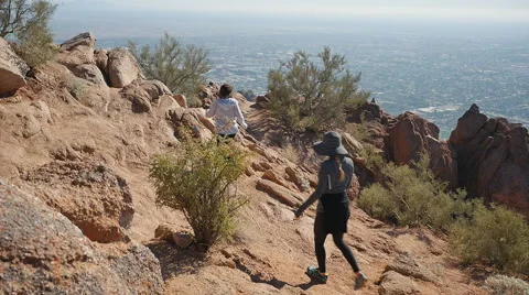 FEMALES HIKE DOWN MOUNTAIN Stock Footage 45203830