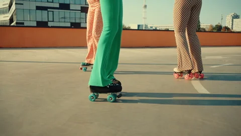 Females legs rollerblading and developing skills on roof Video stock 253995462