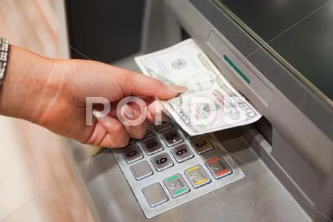 Feminine hand withdrawing dollars Stock Photos
