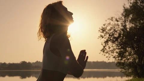 Feminine Strength and Flexibility: Practicing yoga amidst a scenic landscape to Stock Footage 275188440