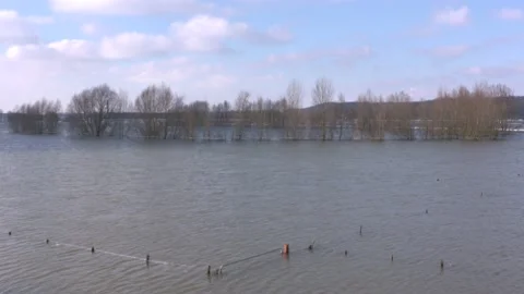 A fence appears above the water surface in the dropping water level Video stock 148751958