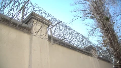 Fence around the prison. barbed wire fences high fence, prevents prisoners Stock Footage 149945079