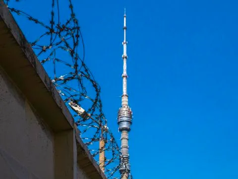 Fence with barbed wire against the backdrop of the Ostankino Tower Stock Photos