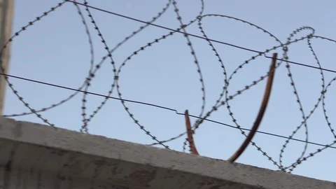 A fence with barbed wire against the sky. Close-up Stock Footage 110863603