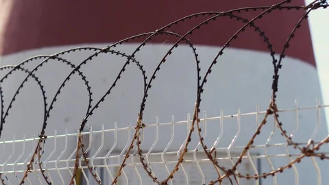 A fence with barbed wire amid a sailing ship in the Mediterranean Sea Stock Footage 118546799