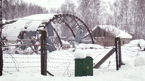 Fence with barbed wire on the background of snowdrifts, iron construction and Stock Footage 117843397
