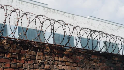 A fence with barbed wire. Colony, prison, correctional camp for prisoners. Stock Footage 285305235