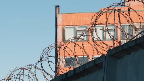 A fence with barbed wire. Colony, prison, correctional camp for prisoners. Video stock 295259620