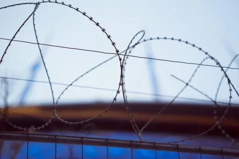Fence with barbed wire. focus with shallow depth of field. Stock Photos