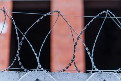 Fence with barbed wire. focus with shallow depth of field. Stock Photos