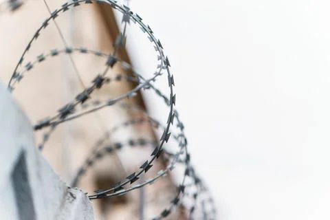 Fence with barbed wire. focus with shallow depth of field. Stock Photos